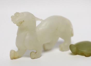 A 19th century Chinese jade model of a lion-dog, 9cm, together with a hardstone ‘tortoise’ pendant